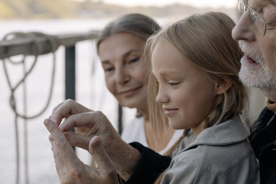 A joyful moment with grandparents and granddaughter sharing time together outdoors.